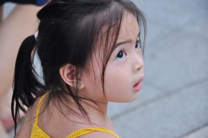 puzzled little girl looking up